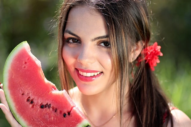 pretty woman eating melon