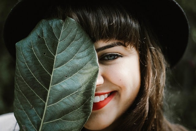 woman hiding and smiling