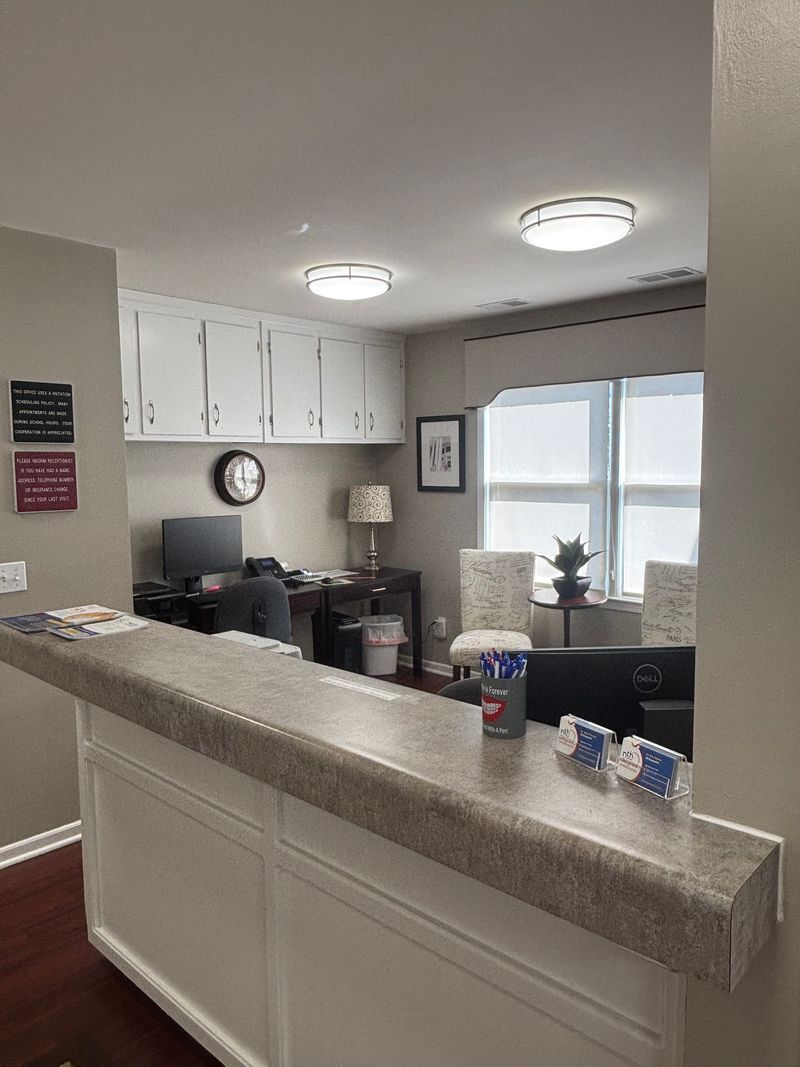 Nth Degree Orthodontics Union office reception area with desk, computer, and waiting chairs.